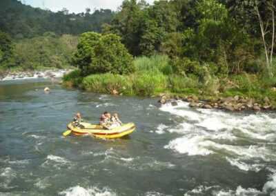 People in a raft on a river in Sri Lanka.